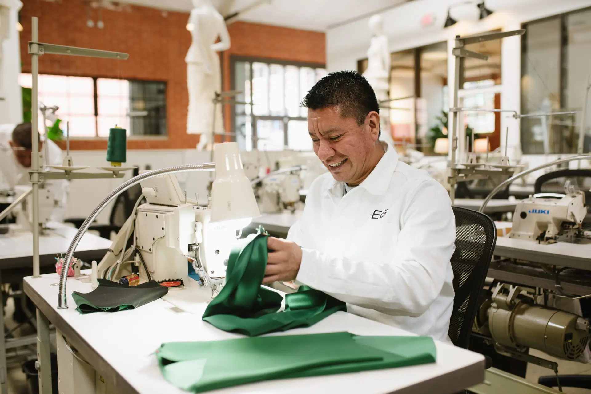 Master artisans drafting custom childrenswear patterns at TEG Los Angeles studio