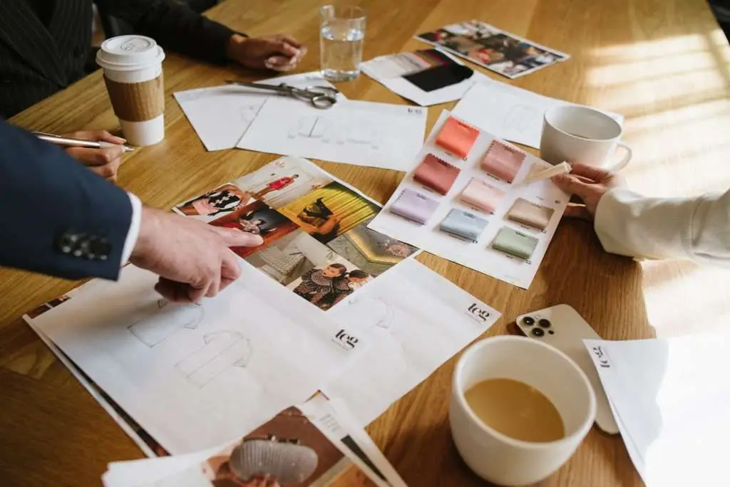 Jennifer Evans consulting with fashion designers on garment development